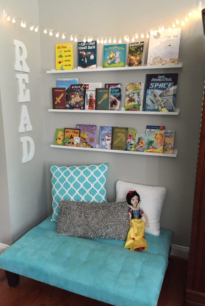 Create this simple reading nook with a child's futon, shelves, string lights and throw pillows.