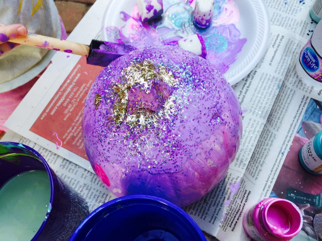 Add glitter to the painted pumpkins to add sparkle