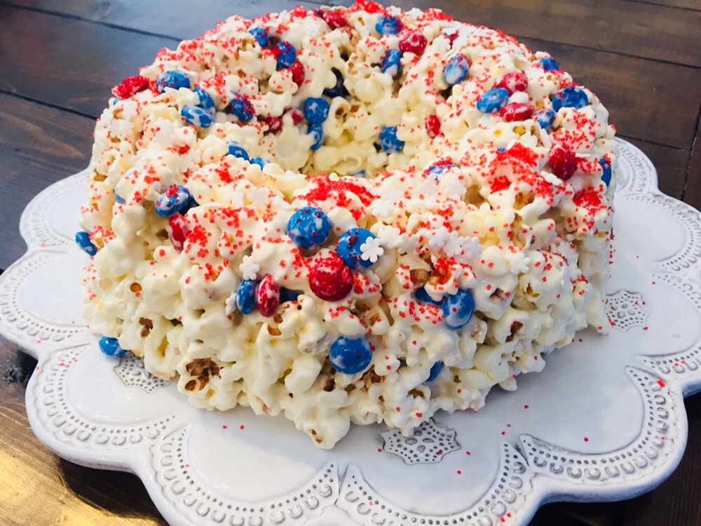 The recipe for Patriotic Popcorn Cake is so simple and perfect to make with kids. You only need a few ingredients and it would be perfect to take to a picnic or 4th of July party!