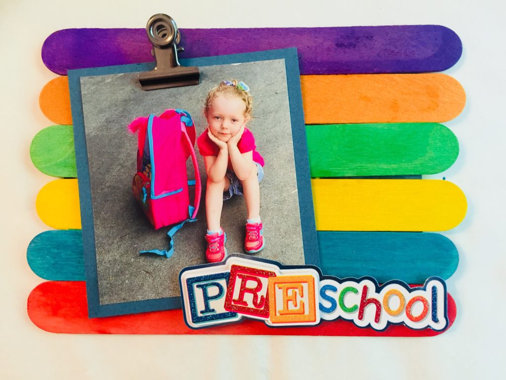 Display those cute first day of school pictures with this easy back to school popsicle stick frame craft. It is so quick to make and the kids will love seeing their photo displayed.