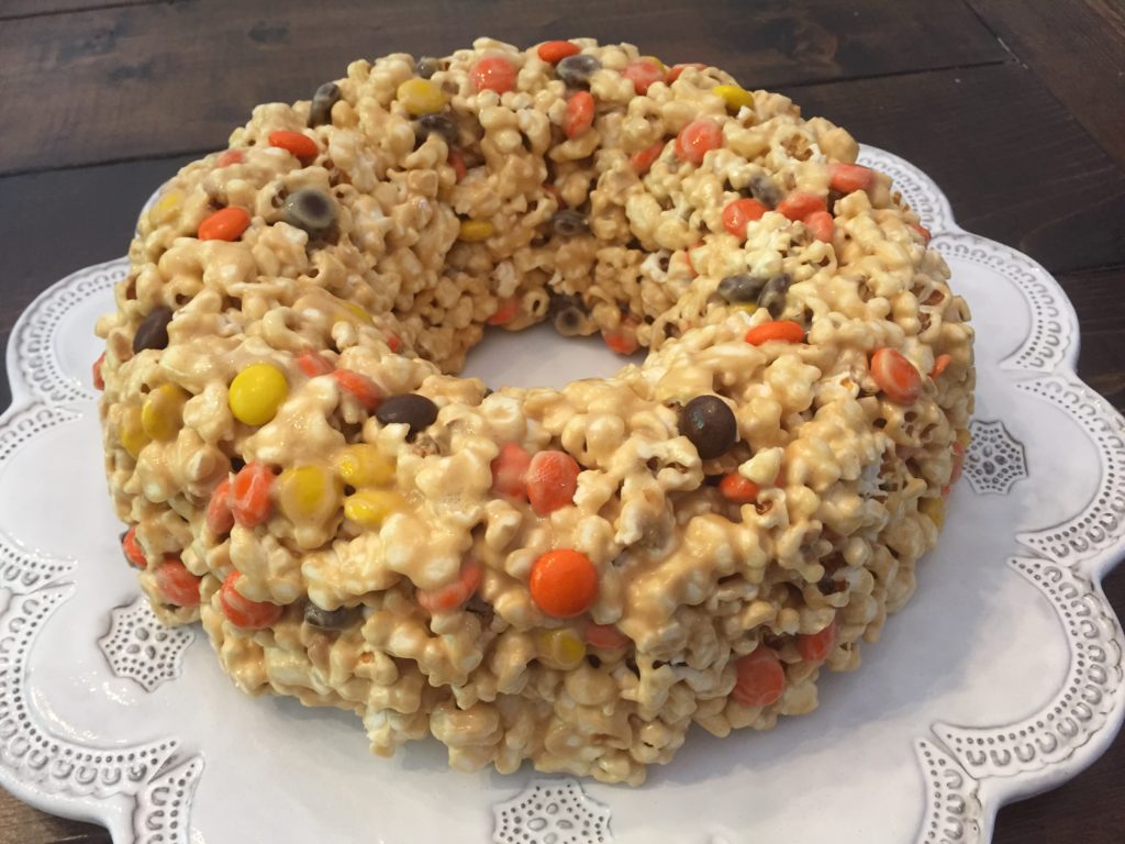 Peanut Butter Popcorn Cake is a fun recipe to make with kids this fall! It is the perfect treat to take to a Halloween Party or Thanksgiving Feast!