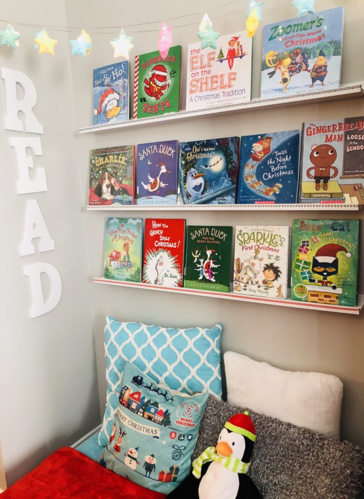 Create a Cozy Holiday Reading Nook with fun Christmas Themed books, pillows, and twinkle lights.