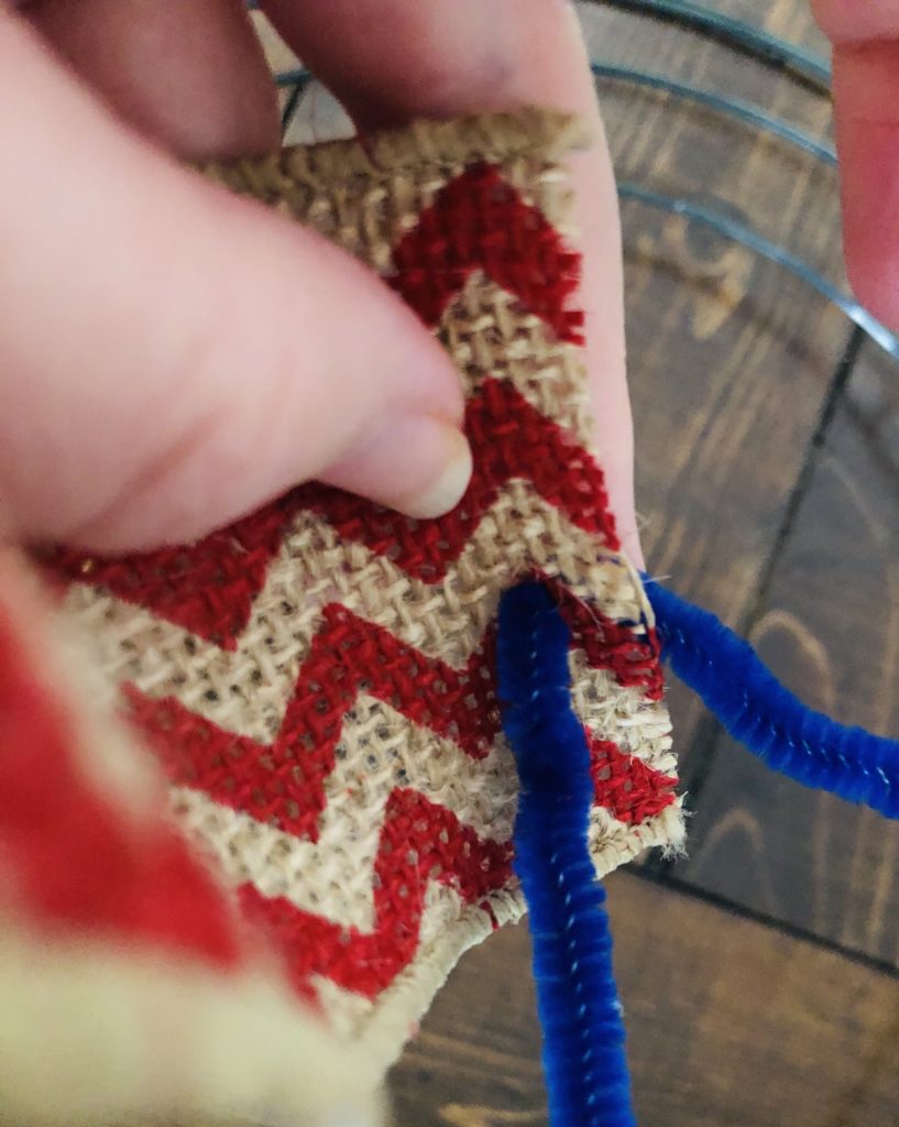 Use Pipe Cleaner to attach ribbon to wreath form.