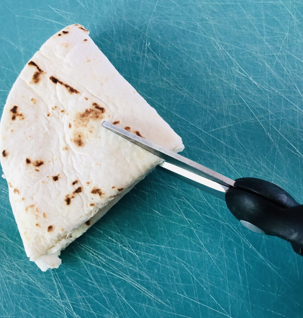 Folding tortillas to create snowflakes