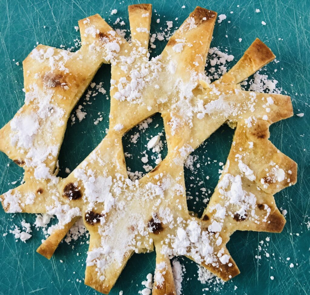 Baked Snowflake Tortillas with Powdered Sugar