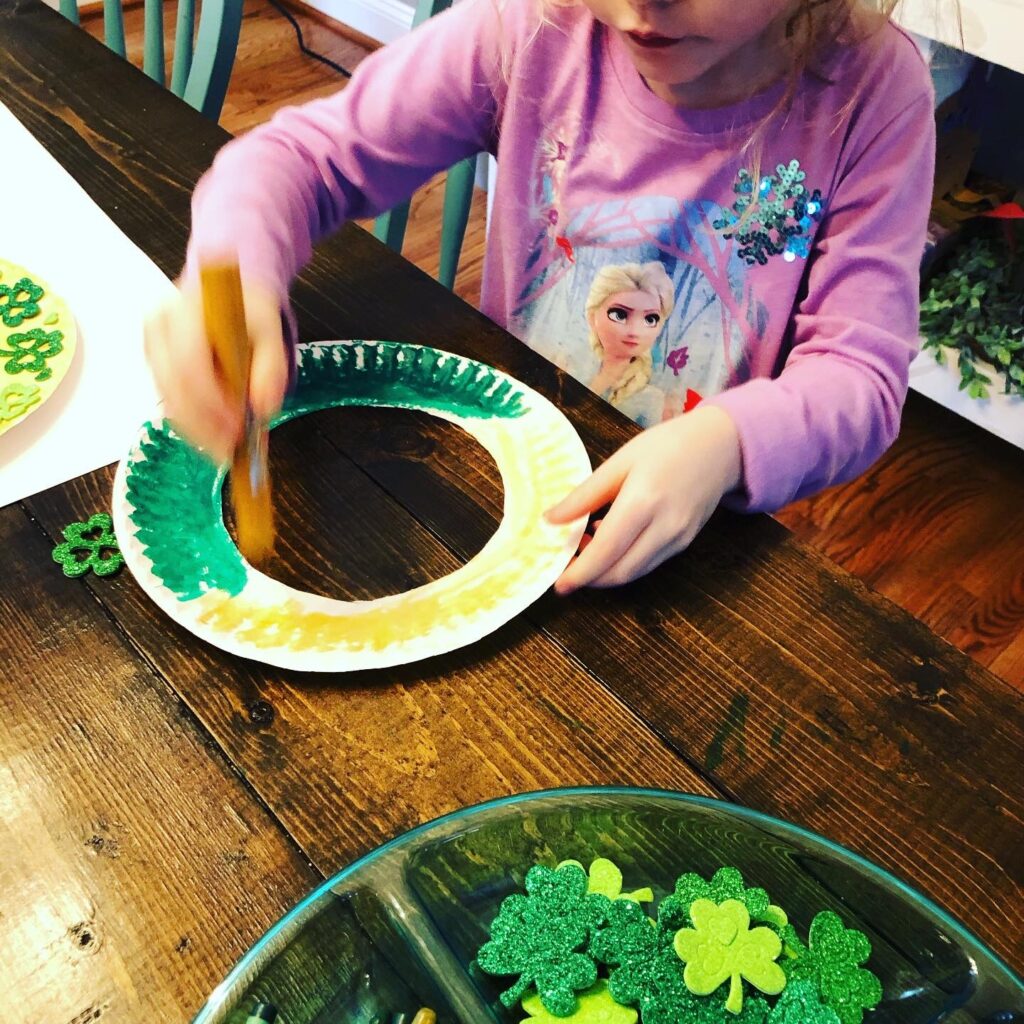 Creating a paper plate shamrock wreath for St. Patrick's Day