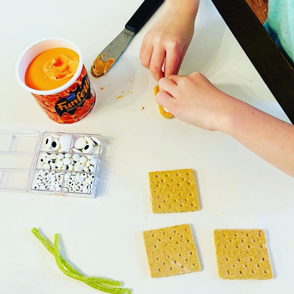 Kids Making Pumpkin Graham Cracker Snacks with Icing